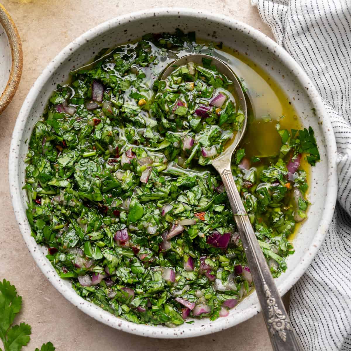 A bowl of Marina's chimichurri — chopped parsley, red onion, chili, oil