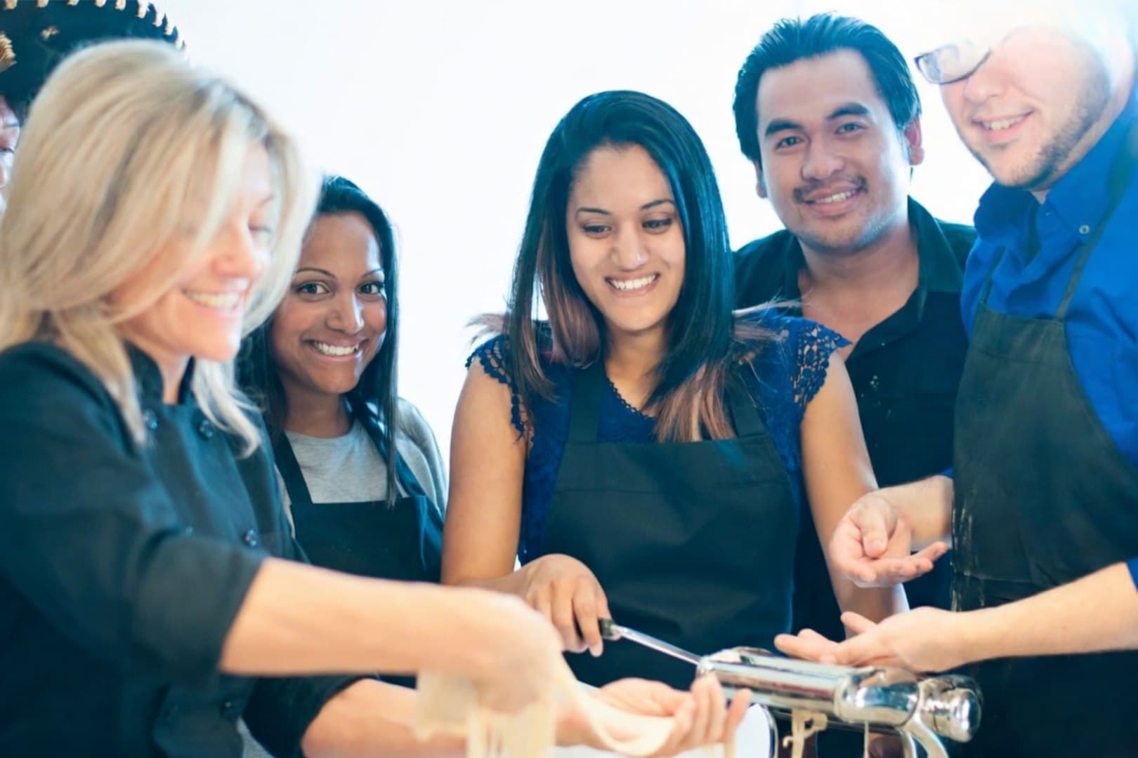 Team rolling fresh pasta together
